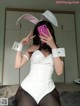 A woman in a bunny costume taking a selfie.