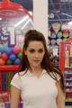 A woman standing in front of a candy store.