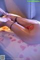 A woman getting a massage with rose petals on her legs.