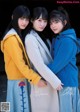 A group of three young women standing next to each other.