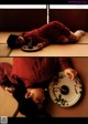 A woman laying on the floor with a plate of food.