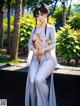 A woman in a white kimono sitting on a bench.